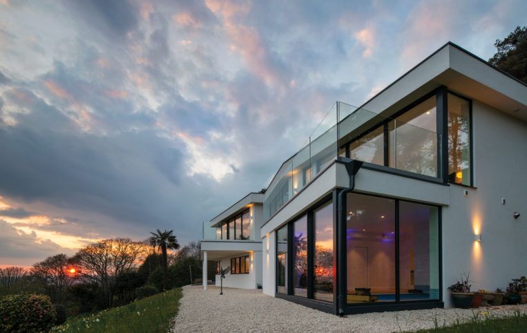 A view of the property on Dorset coast and the new glazing at dusk