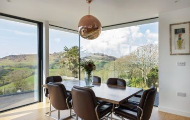 New build house featuring fixed windows that frame the mesmerizing Dorset hills.