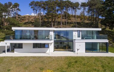 Aluminium sliding doors create walls of glass for new home - frontal shot