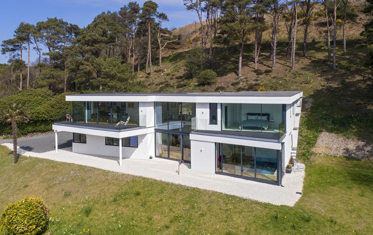 ADrone shot showing aluminium sliding doors on both floors of new home