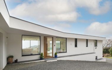 Front entrance to new home with glazed entrance door and two large fixed windows